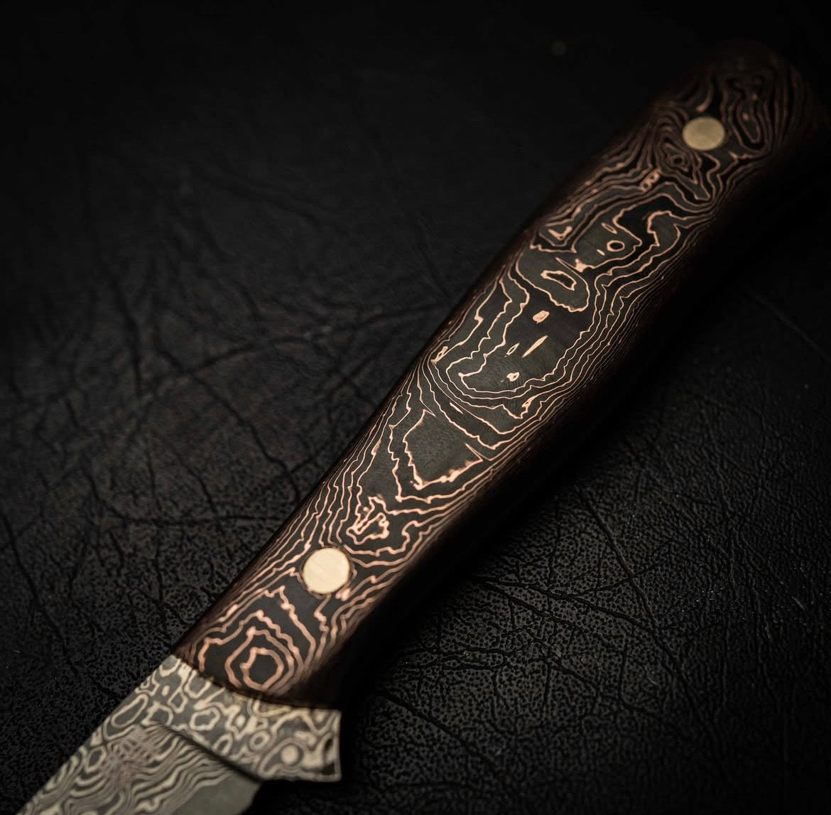 Decorative handle with a patterned handle on a dark textured background